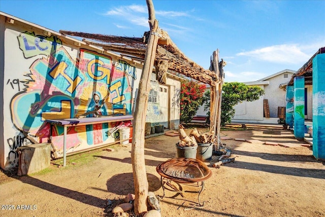 view of patio / terrace featuring an outdoor fire pit