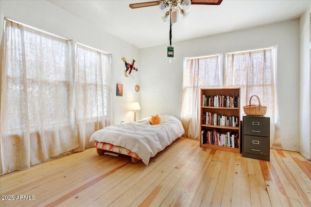 bedroom with a ceiling fan and hardwood / wood-style flooring