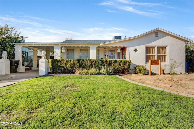 view of front of house with an attached carport, a front lawn, and stucco siding