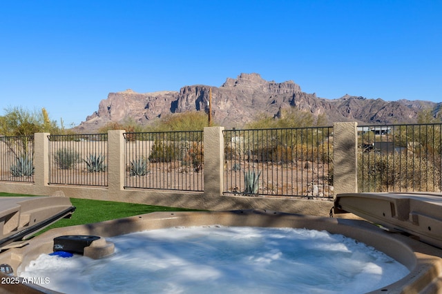 exterior space featuring a mountain view and fence