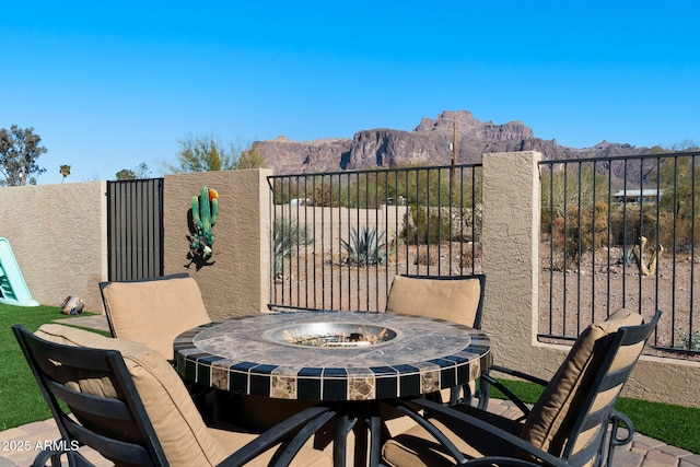 view of patio / terrace with a mountain view and fence