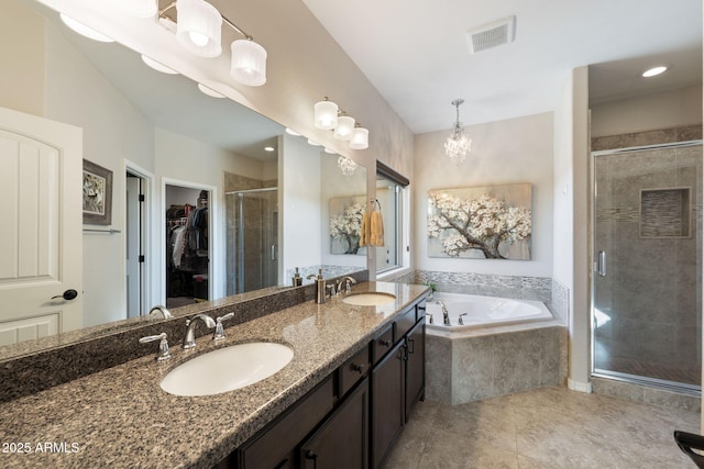 bathroom with a sink, visible vents, a spacious closet, and a shower stall