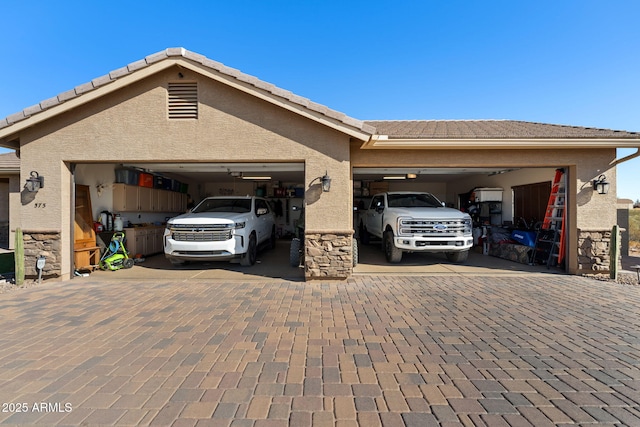 garage with decorative driveway