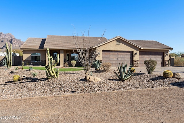 single story home featuring a tile roof, a garage, and stucco siding