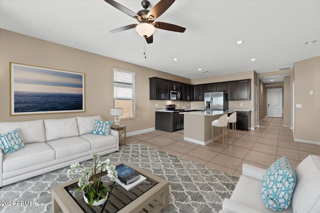 living room featuring ceiling fan and light tile patterned flooring