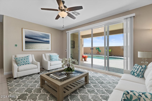 living room with ceiling fan and tile patterned floors