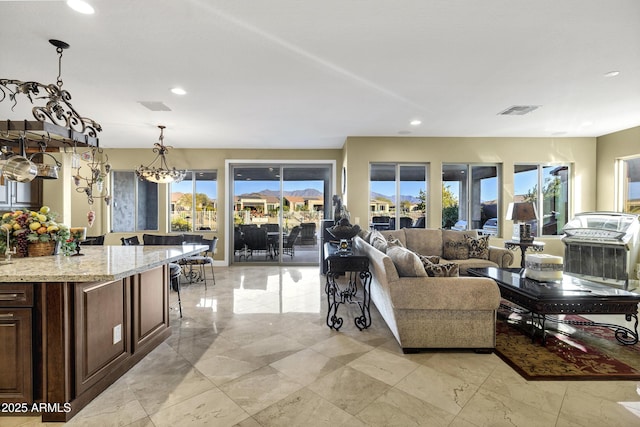 living room featuring a wealth of natural light and an inviting chandelier