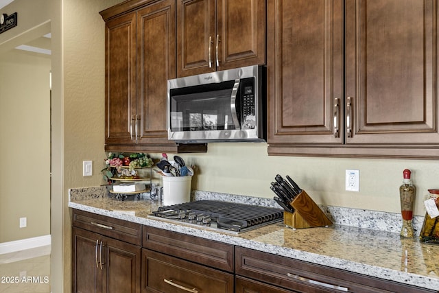 kitchen with light stone countertops and stainless steel appliances