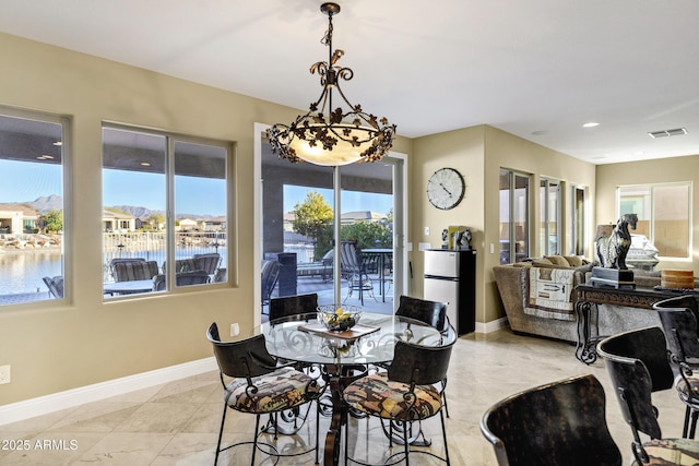 dining room featuring a water view