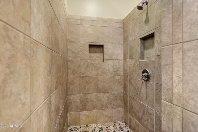 bathroom with a tile shower