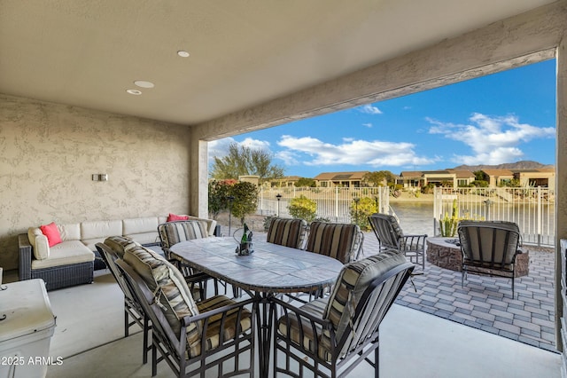 view of patio with outdoor lounge area and a water view