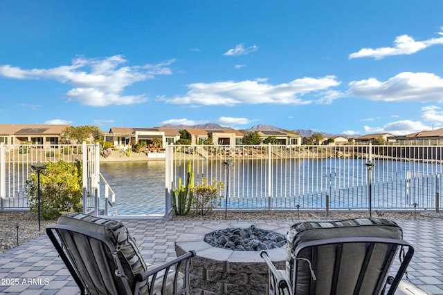 view of patio / terrace featuring a water view and an outdoor fire pit