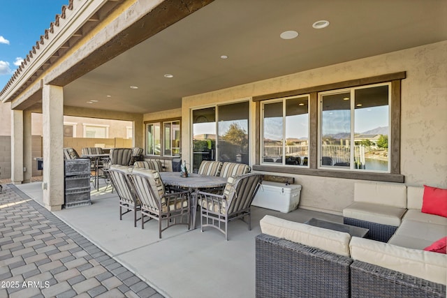 view of patio / terrace with an outdoor living space and a water view