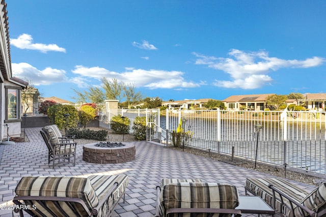 view of patio / terrace featuring a water view and an outdoor fire pit