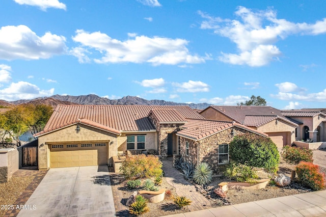 view of front of property with a garage and a mountain view