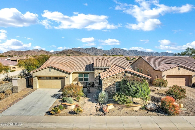 view of front of home featuring a mountain view and a garage