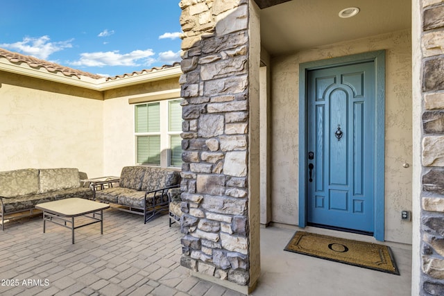 doorway to property with an outdoor living space