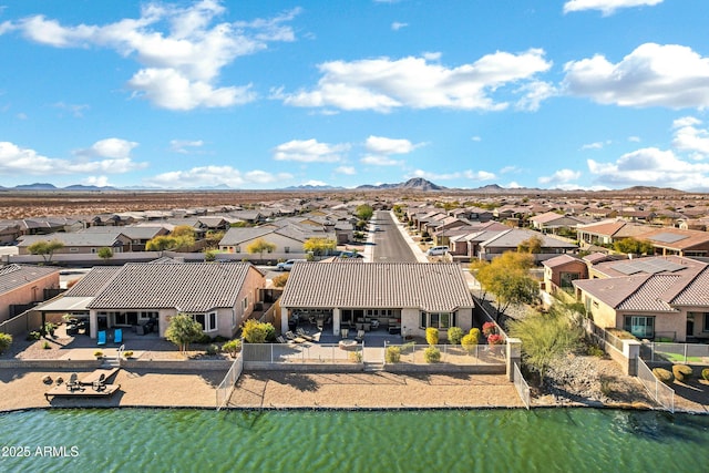 drone / aerial view with a water and mountain view