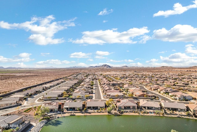 drone / aerial view featuring a water and mountain view