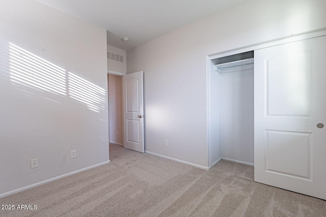 unfurnished bedroom featuring a closet, baseboards, carpet, and visible vents