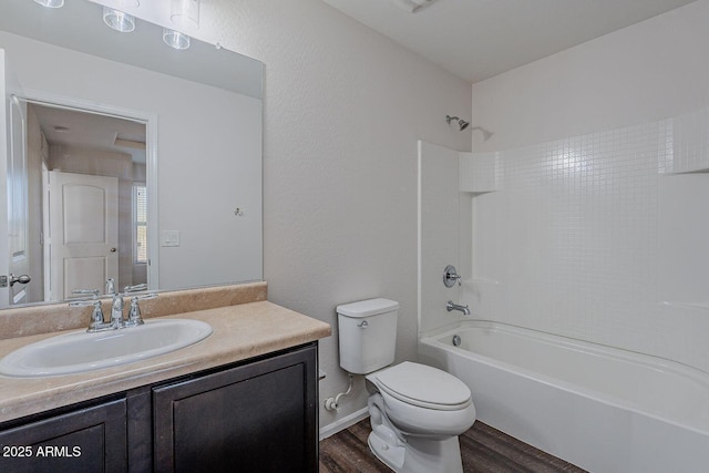 full bathroom with visible vents, toilet, wood finished floors,  shower combination, and vanity