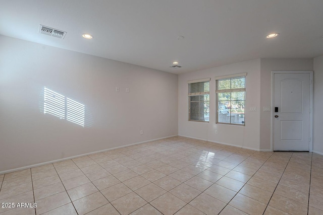 empty room with light tile patterned flooring, visible vents, recessed lighting, and baseboards