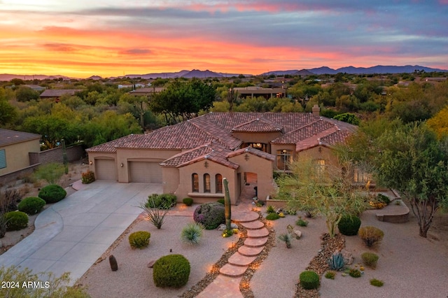 view of front of home with a mountain view and a garage