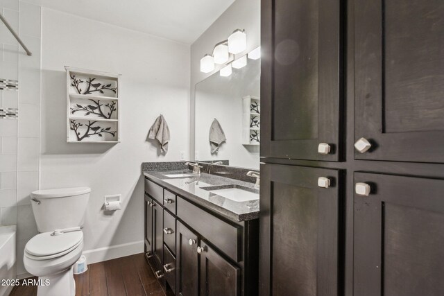 1649 W Royal Palm Rd, Phoenix, AZ 85021 - bathroom featuring baseboards, toilet, wood finished floors, double vanity, and shower / bath combination