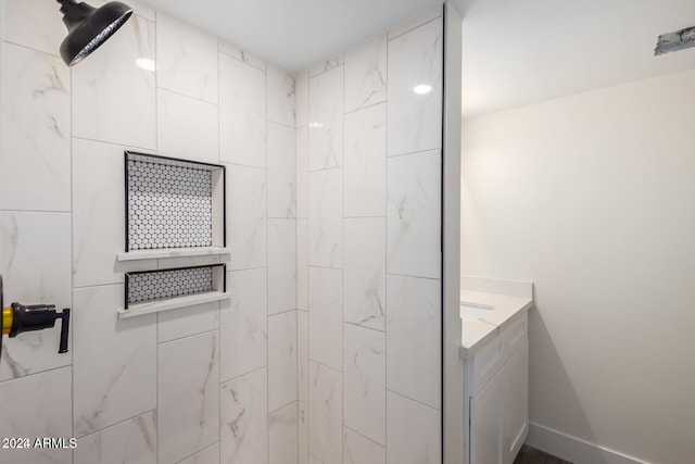 bathroom featuring vanity and tiled shower