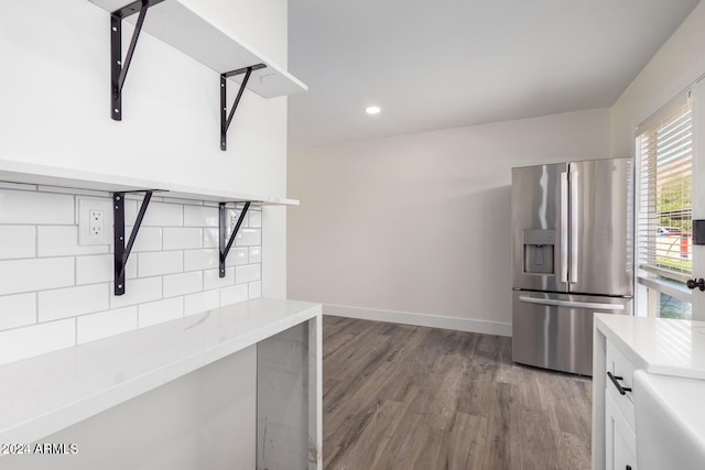 kitchen featuring stainless steel fridge, white cabinetry, and dark wood-type flooring