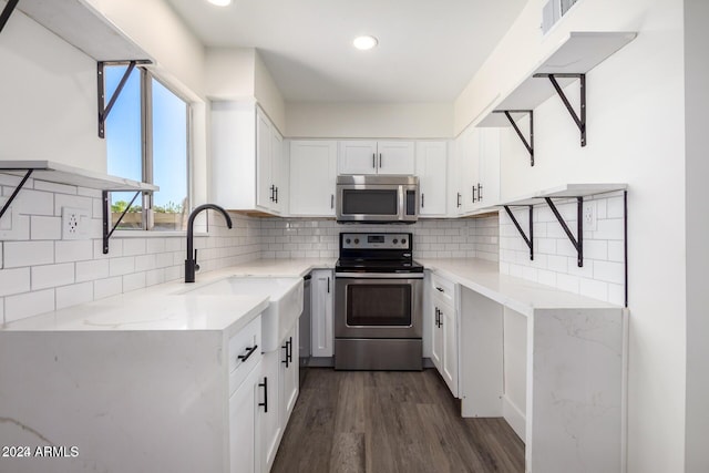 kitchen featuring white cabinetry, sink, stainless steel appliances, dark hardwood / wood-style flooring, and decorative backsplash