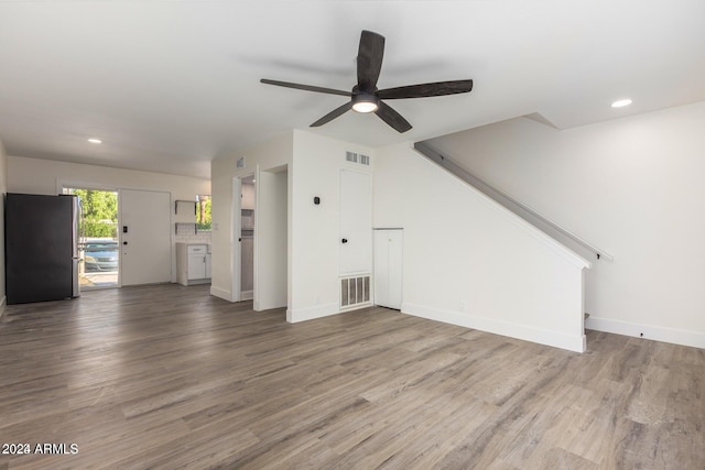 unfurnished living room featuring hardwood / wood-style flooring and ceiling fan