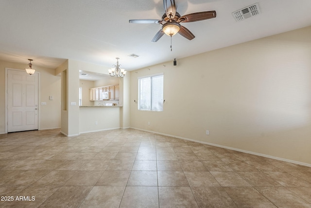 unfurnished room featuring visible vents, baseboards, and ceiling fan with notable chandelier