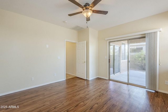 unfurnished room featuring ceiling fan, visible vents, baseboards, and wood finished floors