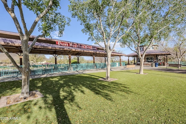 view of home's community with a gazebo, a yard, and fence