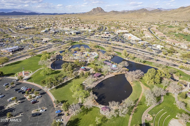 drone / aerial view with a water and mountain view