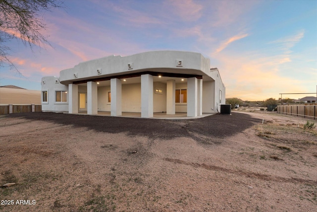 28301 N 154th St, Scottsdale, AZ 85262 - back of house at dusk with stucco siding, fence, and central air condition unit