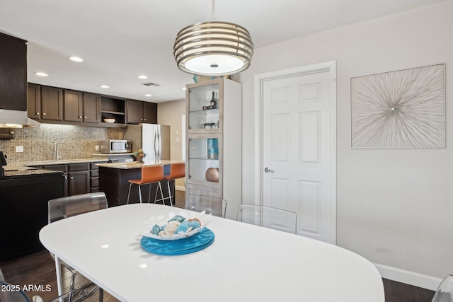 8107 E Mitchell Dr, Scottsdale, AZ 85251 - dining space featuring dark wood finished floors, recessed lighting, baseboards, and visible vents