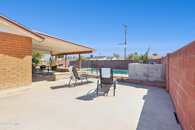 8107 E Mitchell Dr, Scottsdale, AZ 85251 - view of patio with outdoor dining space, a fenced backyard, and a fenced in pool