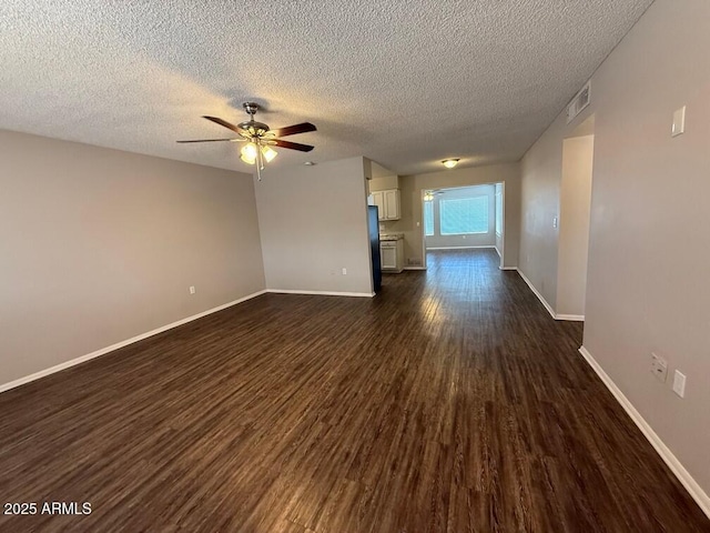 unfurnished living room with ceiling fan, a textured ceiling, and dark hardwood / wood-style flooring