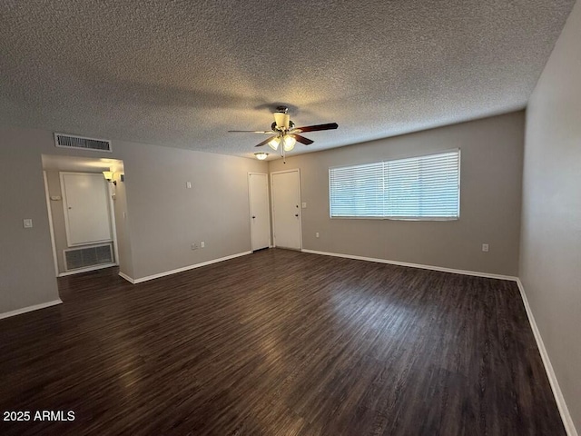 empty room with dark hardwood / wood-style flooring, ceiling fan, and a textured ceiling