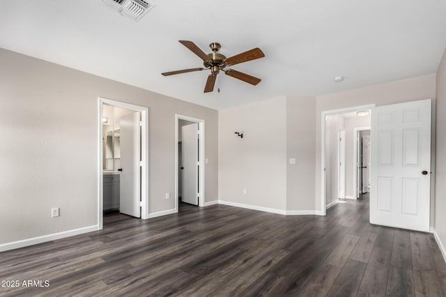 unfurnished bedroom featuring ceiling fan, visible vents, baseboards, dark wood-style floors, and connected bathroom