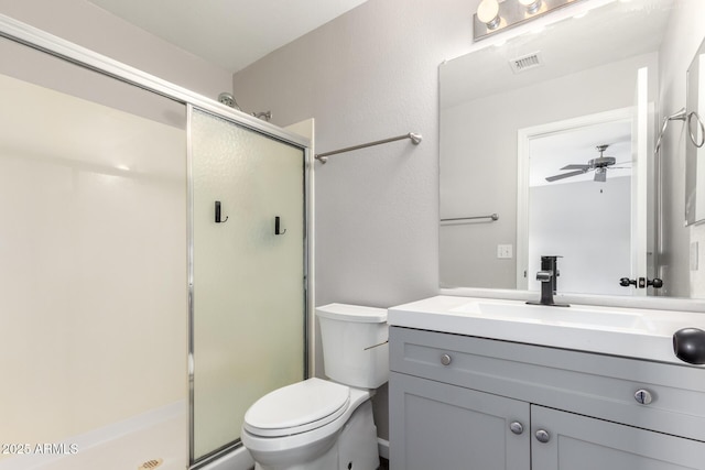 bathroom with toilet, visible vents, a shower stall, and vanity