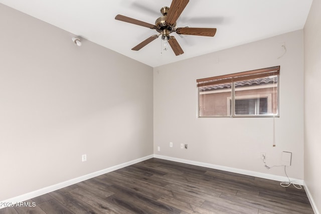 unfurnished room with baseboards, a ceiling fan, and dark wood-type flooring