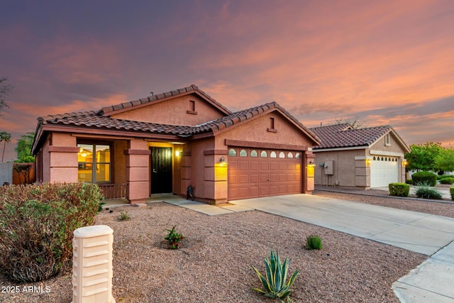 ranch-style home with an attached garage, a tile roof, stucco siding, a porch, and concrete driveway