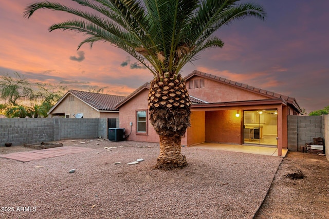 back of property featuring central air condition unit, fence, a patio area, and stucco siding