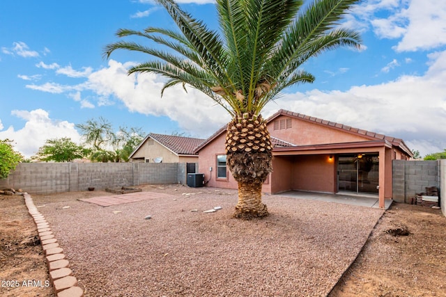 back of property featuring central air condition unit, a fenced backyard, a patio area, and stucco siding