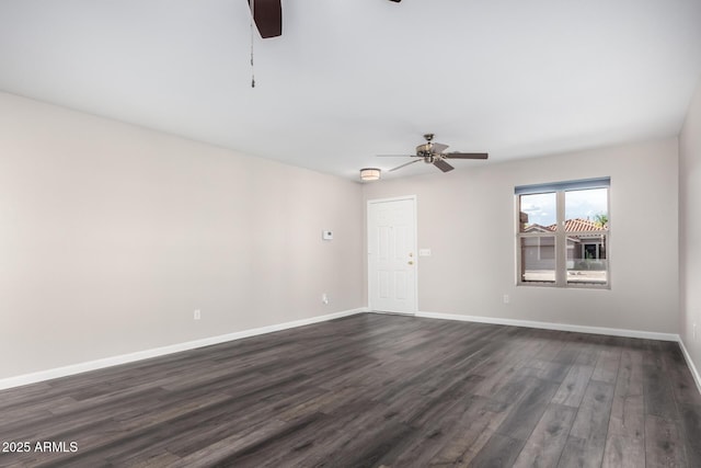 unfurnished room featuring baseboards, a ceiling fan, and dark wood-style floors