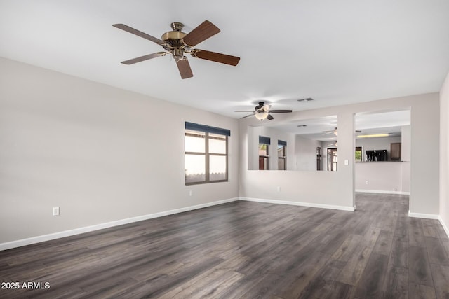 unfurnished living room featuring visible vents, a ceiling fan, dark wood-style flooring, and baseboards