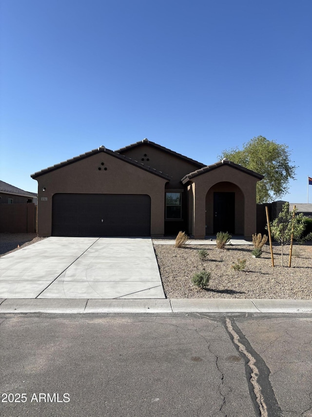 5782 E Orion Rd, Florence, AZ 85132 - mediterranean / spanish home with a garage, stucco siding, and driveway